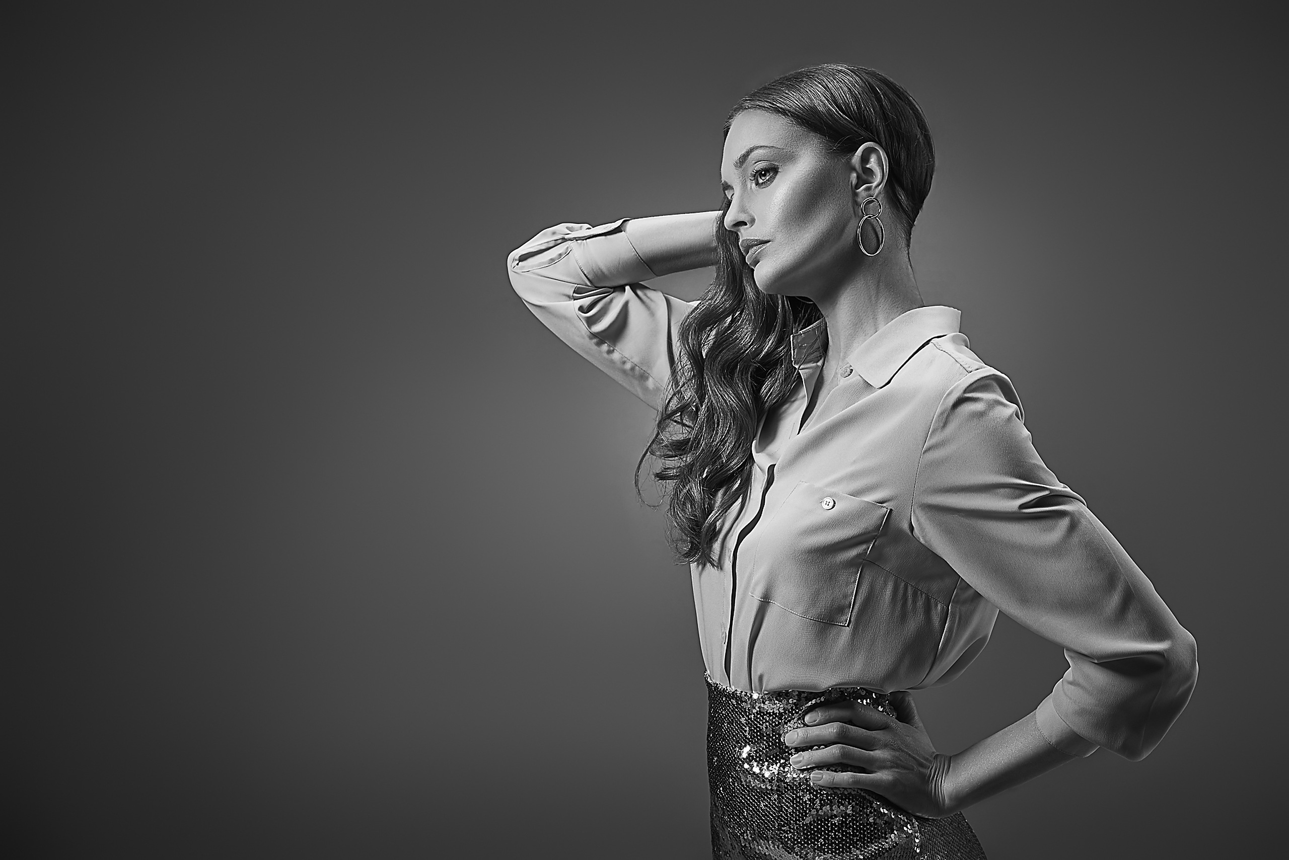 Gold-lit campaign shoot capturing product launch imagery with a model on a studio backdrop