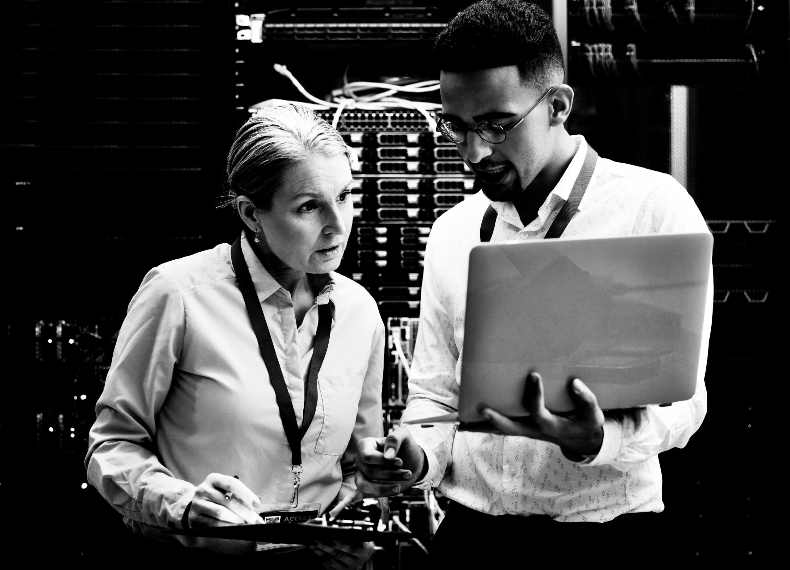 Connecting you is what they do. Shot of two technicians working together in a server room